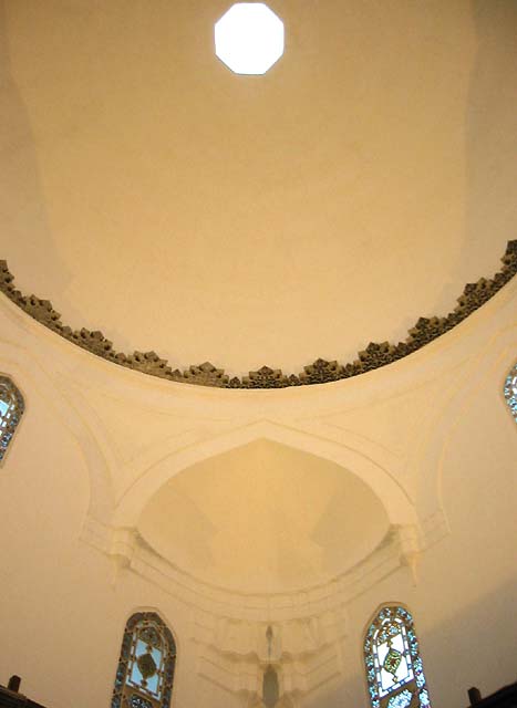 Detail from the dressing room of the men's section, showing corner squinch of dome adorned with muqarnas and decorative cornice above