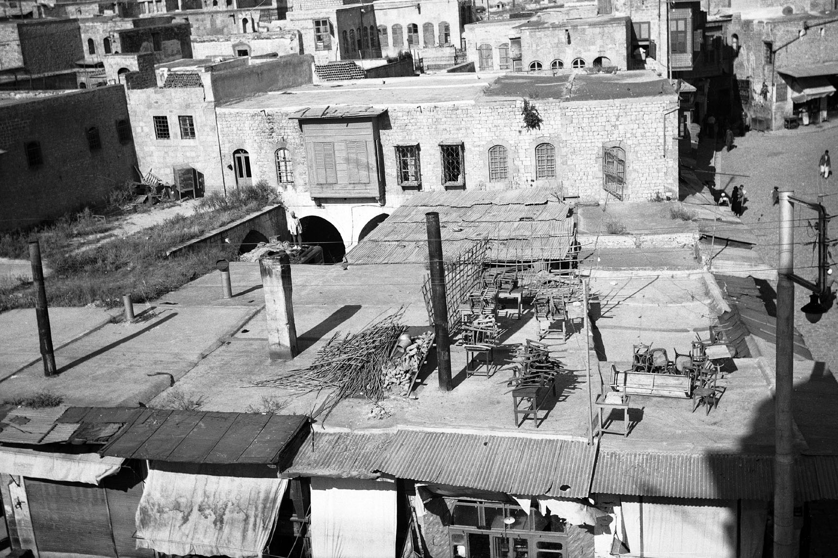 Section of public square known as Bab al-Faraj seen in 1937, part of the surrounding fabric of the gate demolished in 1904. Rooftops