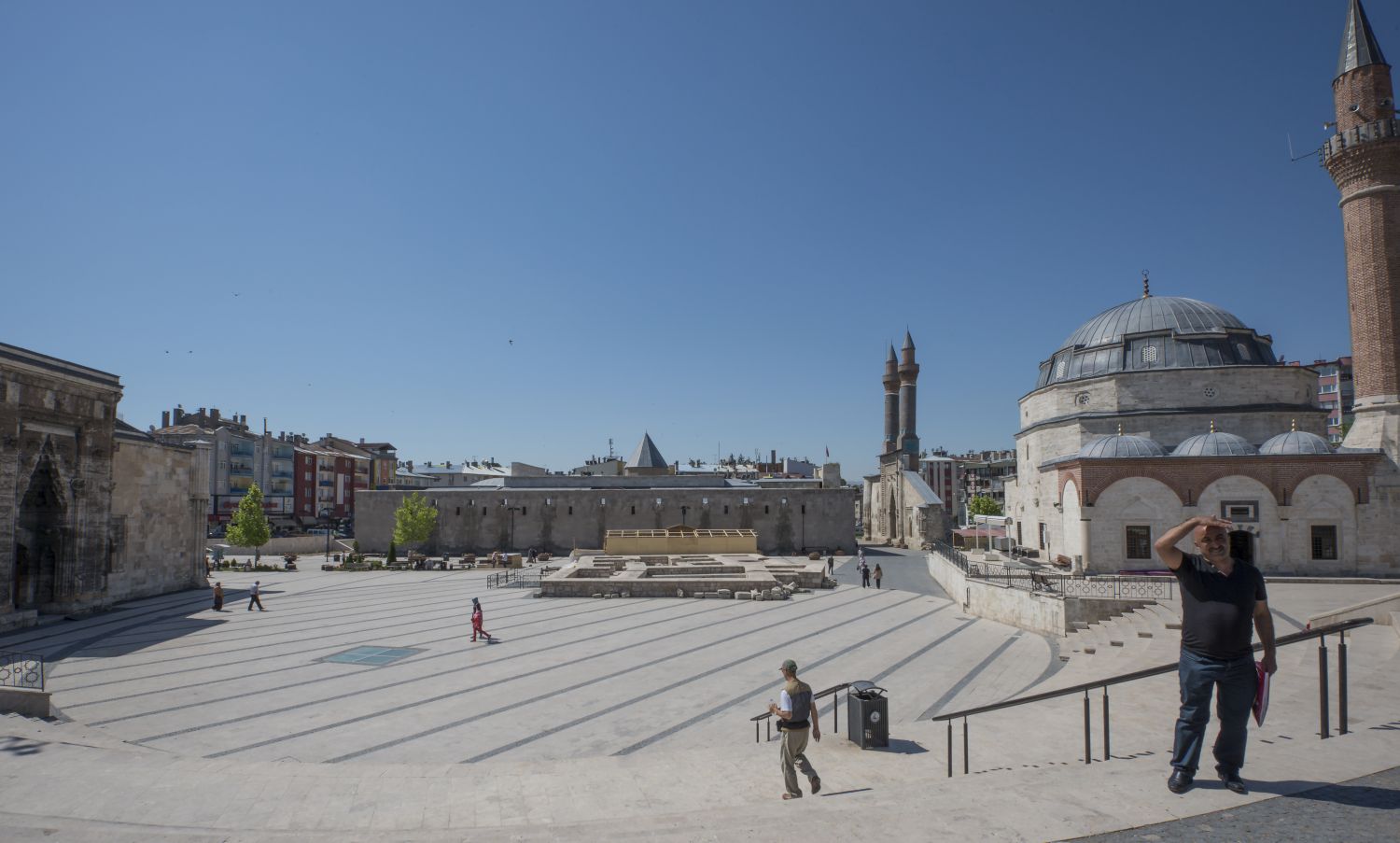 View of town square from northeast. Kale Camii is visible on the right, with the twin minarets of Cifte Minareli Medrese rising in background. Toward the center is the north face of the Sifaiye Medresesi. In the foreground Buruciye Medresesi.