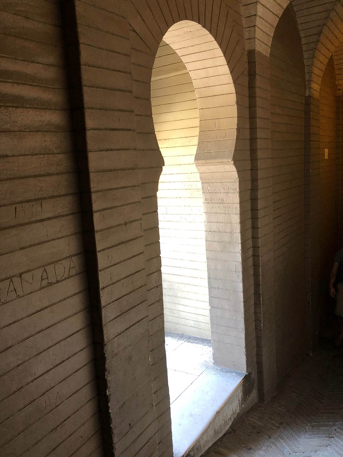View of rounded horseshoe arch window from La Giralda's interior stairs.