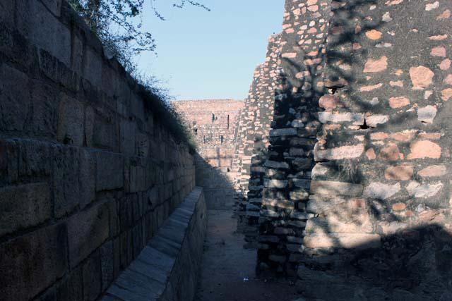View of the triangular buttresses supporting the dam along its southern edge and the rubble wall that retains the flat terrace-like formation to the south of the dam