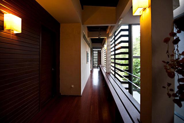 Ambi House - View of the open corridor and the communal bench on the top floor outside the bedrooms