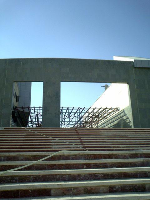 Stairs leading to the main entrance on the east elevation during construction