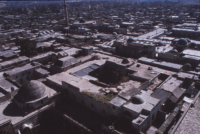 View over the Madrasa al-Halawiyya, the souqs and the minaret of Jami' al-Umawai. The souq was largely destroyed in the Syrian civil war.