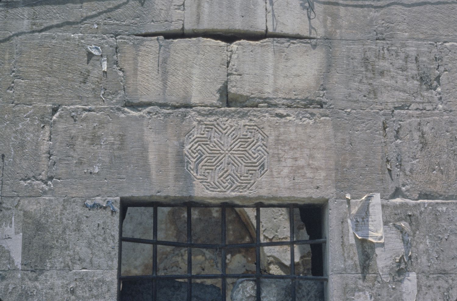 Window with decorative medallion on lintel.