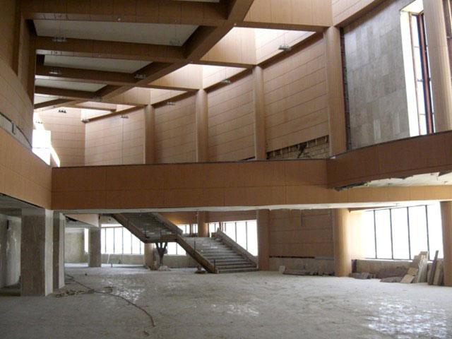The amphitheatre's main lobby covered in washed travertine and wood panelling