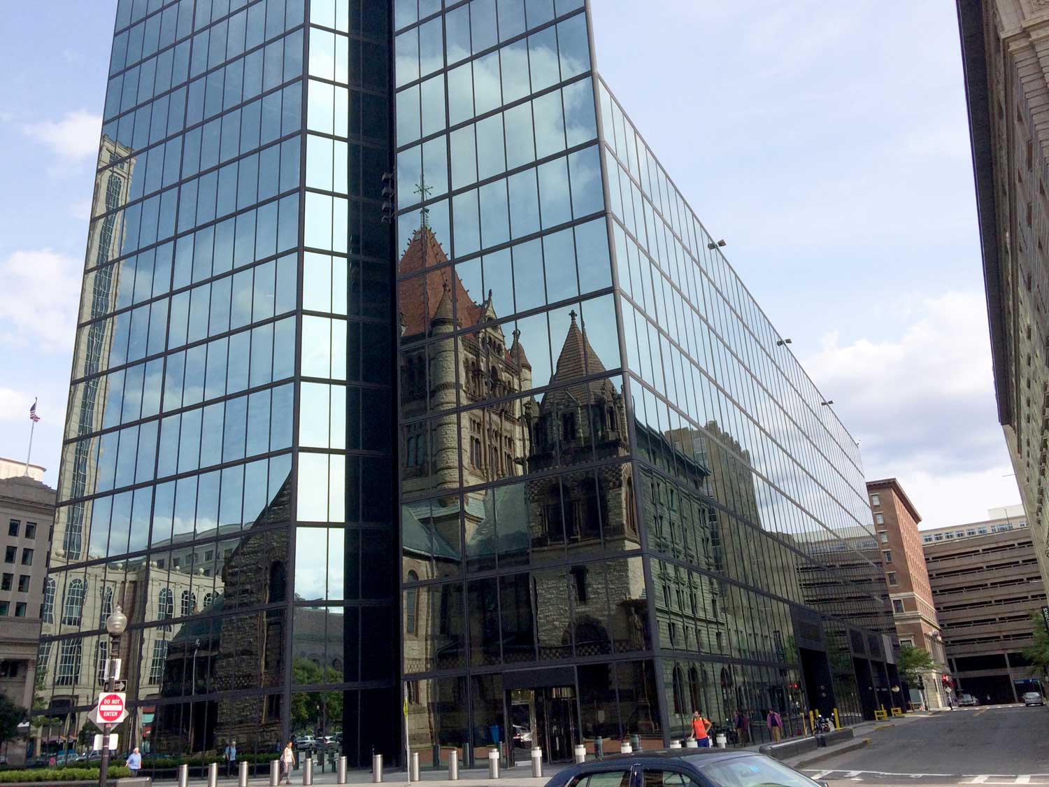 <p>The facade of Trinity Church reflected in the glass of Hancock Tower base, NE corner</p>