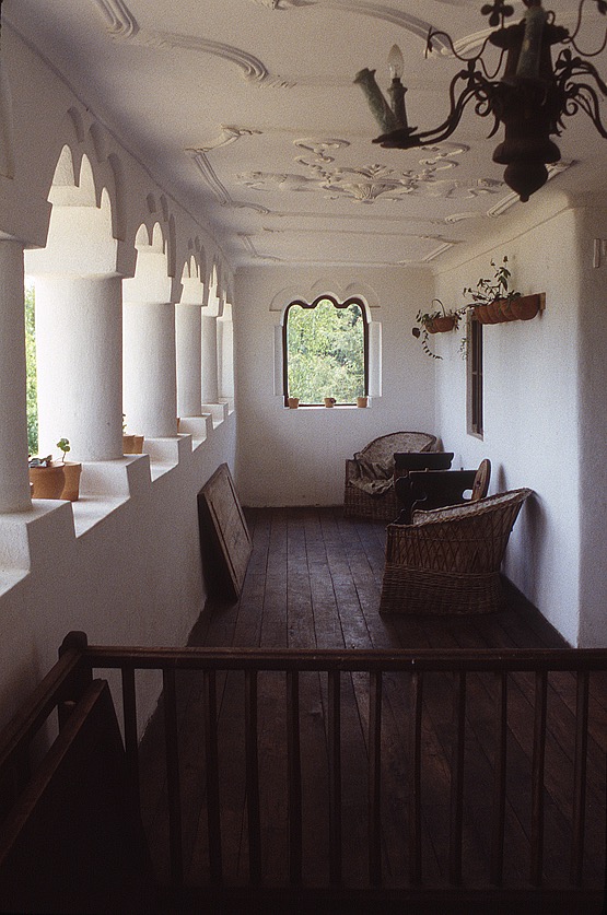 <p>The cerdac provides a large covered space to enjoy the view to the fields, orchards, and valley to the east. The seven trilobite (trefoil) arches and six short thick columns form the openings on the eastern side of the top level. The ceiling has plaster reliefs added in the late 19th and early 20th centuries. The wooden railing in the foreground surrounds the opening for a stair from below. The cula was renamed after its later owner, I.G. Duca, who purchased the site in 1910.</p>