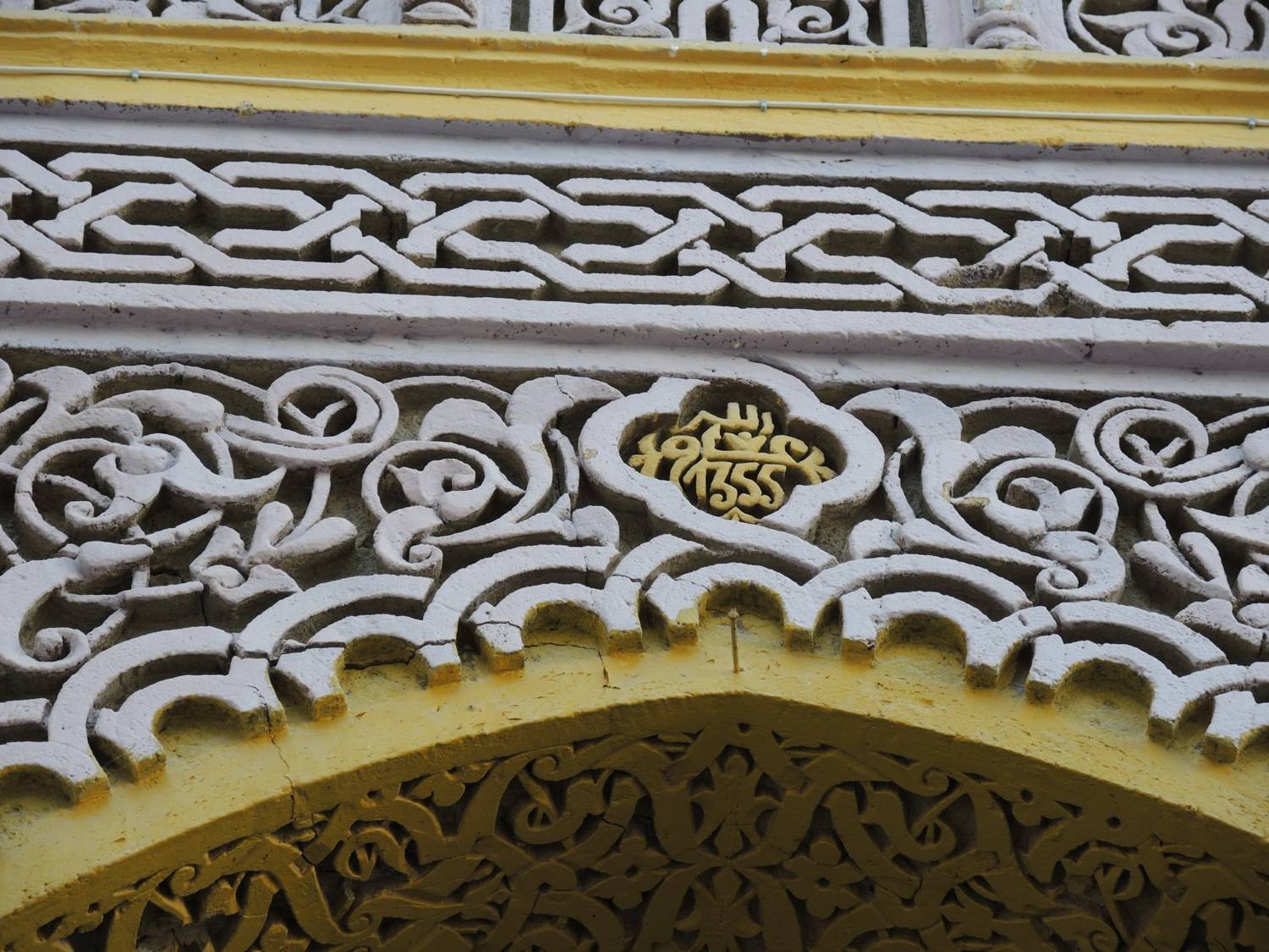 Detail view of the date in stucco above the main portal