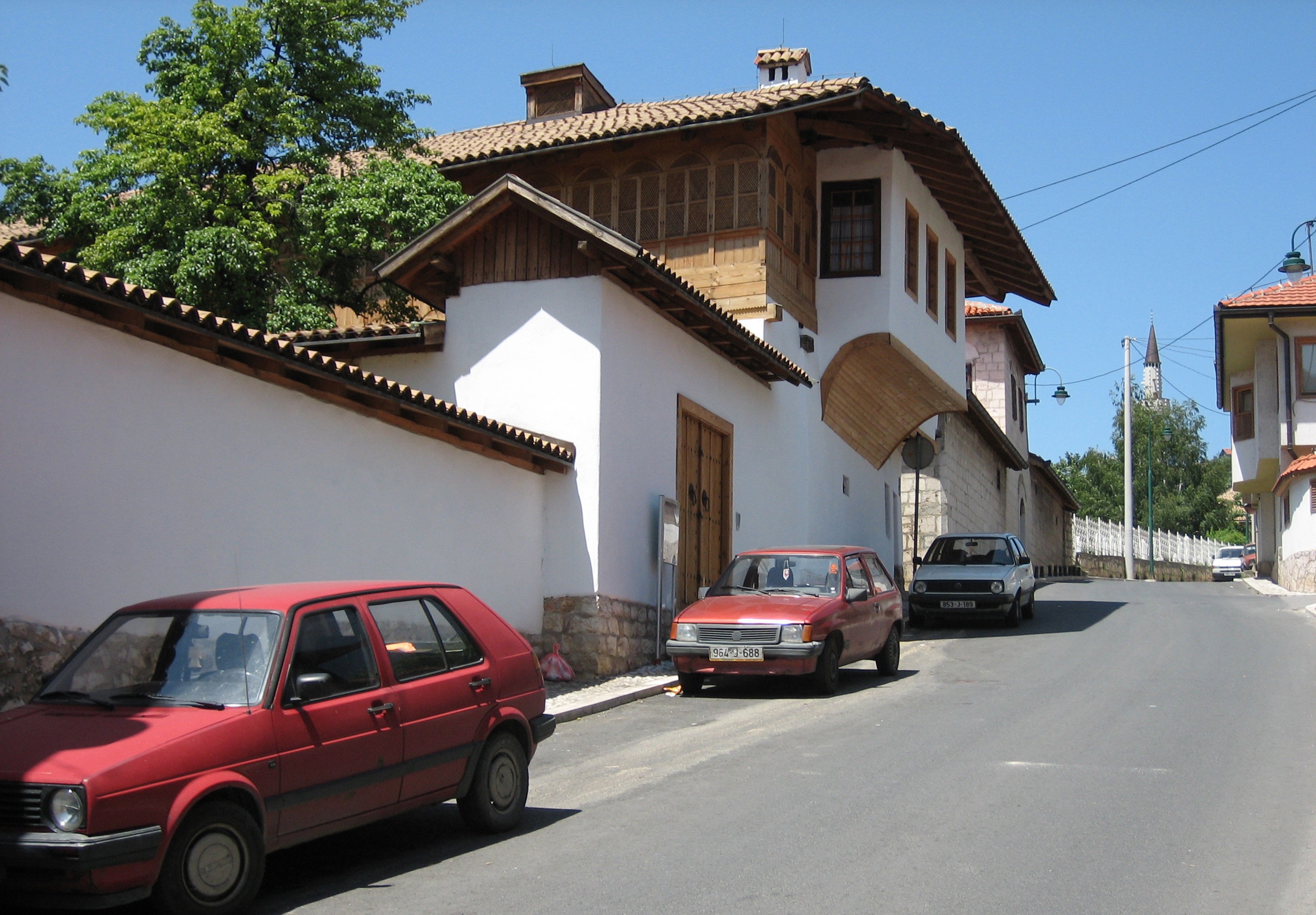 <p>The Alija Djerzeleza kuća was constructed in the 17th century and includes two walled courtyards close to the structure as well as a large orchard that extends to the south and west. The northern wall of the house forms the edge of the street to the north. The house was owned by the Cejvan family for an extended period. Conservation and restoration work began in the late 1990s and more detailed work on structural stabilization and interior and trim work was ongoing in 2004. The work was overseen by the Cantonal Institute for the Protection of Cultural, Historical, and Natural Heritage of Sarajevo.</p>