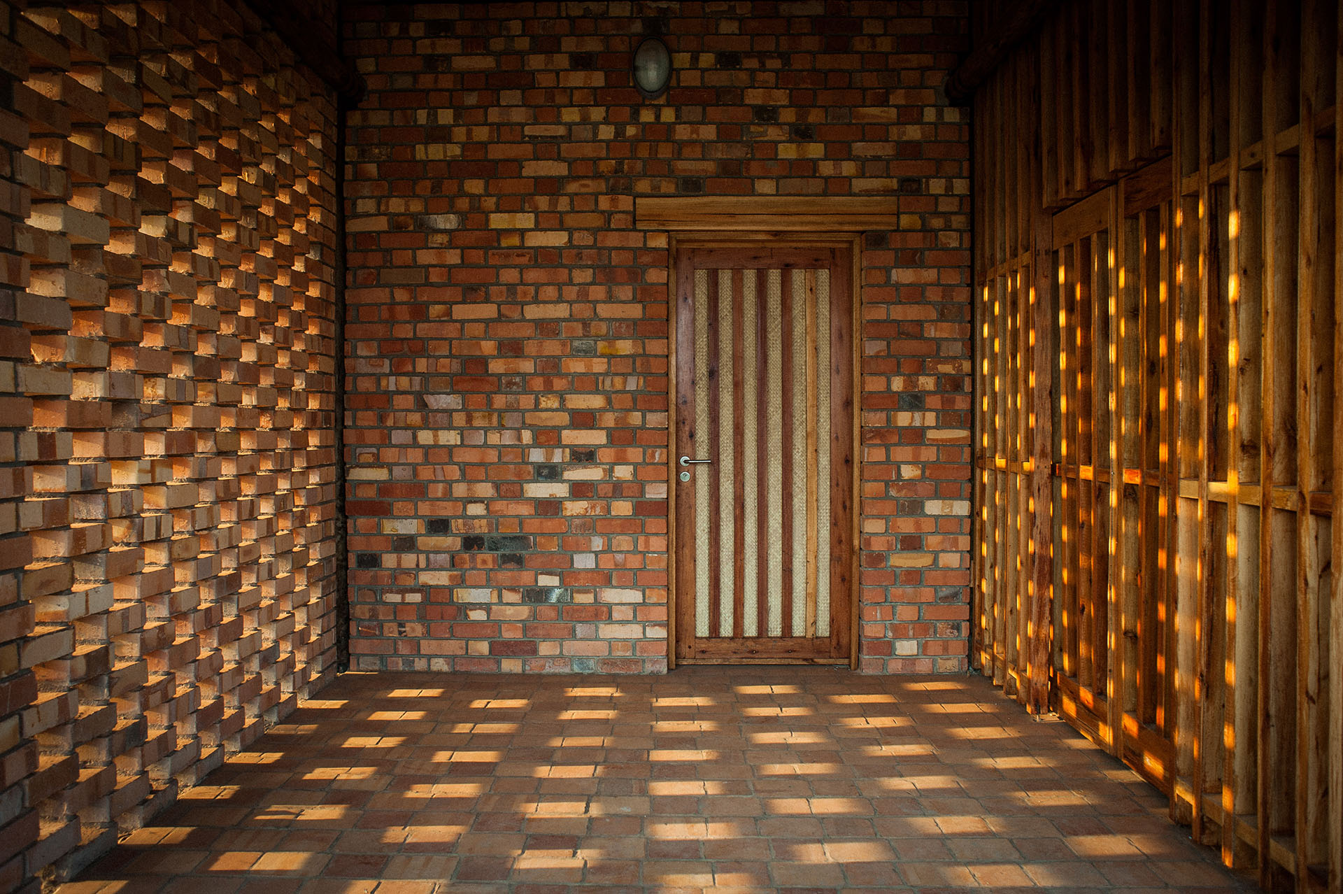 <p>Interior view of vestibule showing breeze wall and timber louvred door.</p>