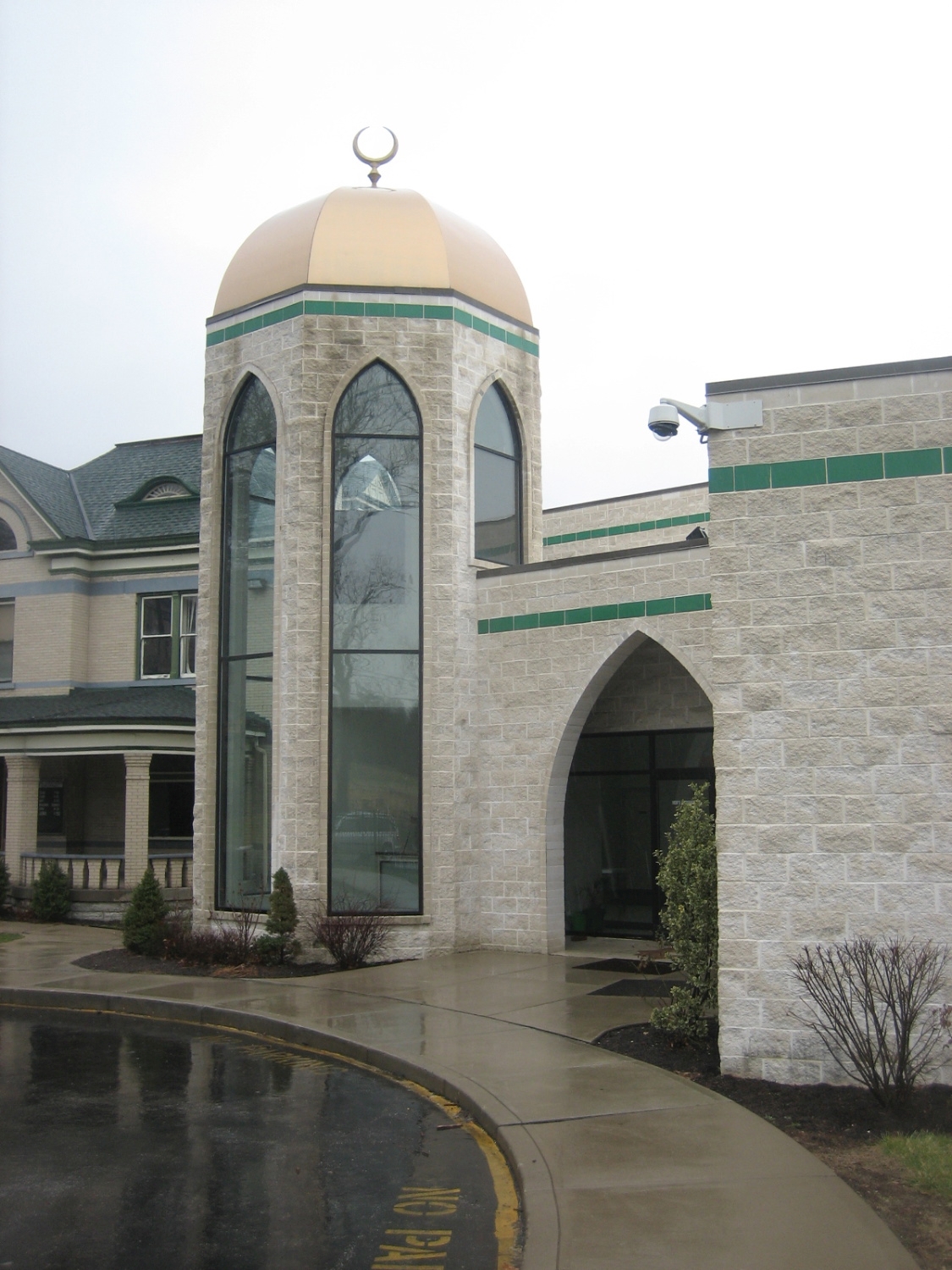 Tower topped with a gold dome at the mosque entrance