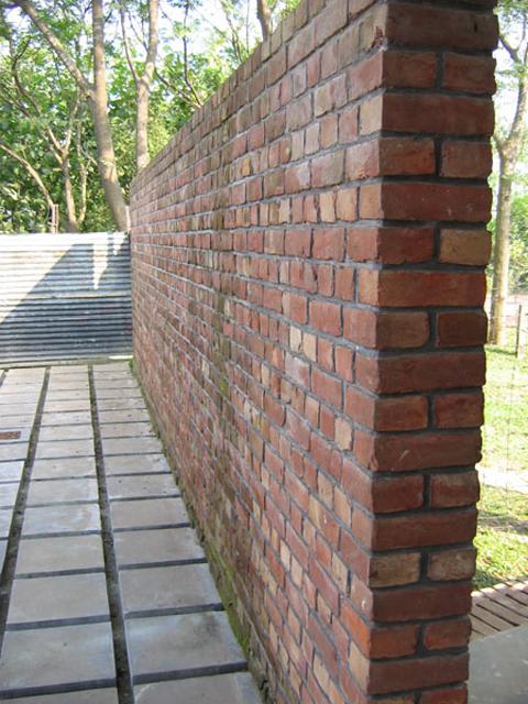 Free standing brick wall enclosing outdoor space