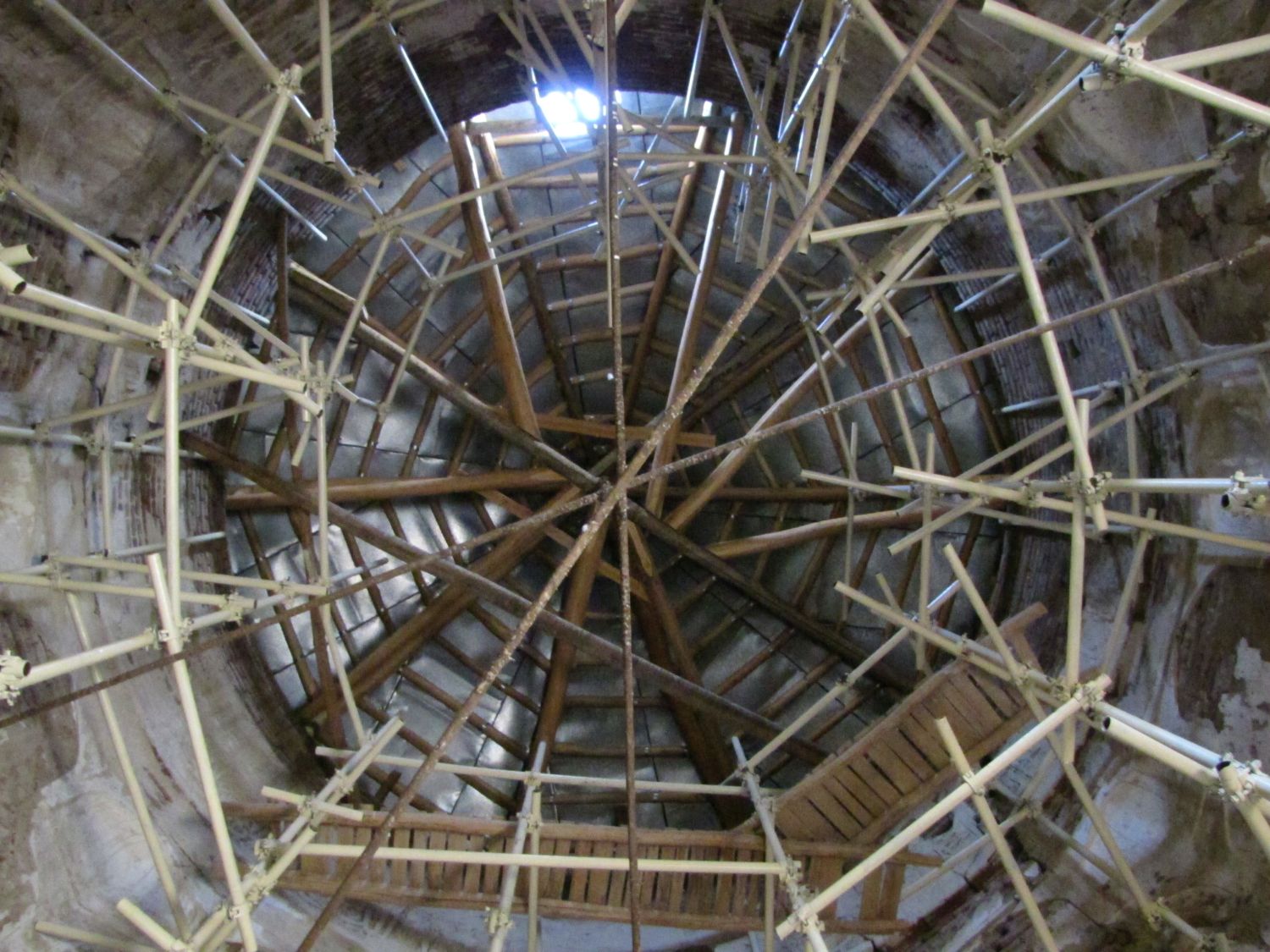 Interior view up at dome with scaffolding and stays in place