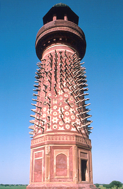Exterior close-up view of tower showing surface decorations and projecting elements