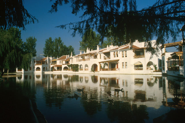 Exterior view across water to terraces