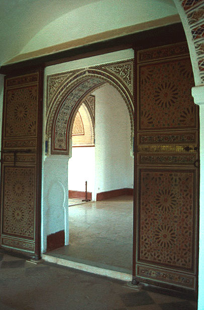 Pavilion interior, carved wood doorway to upper story