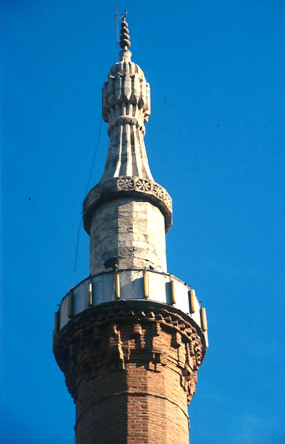 Detail from northeast minaret showing brick stalactite of the serefe and carved stonework of the spire