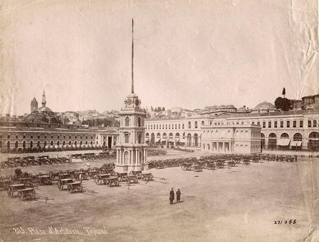 Tophane Promenade (MEGT) - View looking west from behind the mosque to the artillery barracks preceded by an open parade ground; built at the same time as the mosque, the barracks were demolished in the 1950s. At the center, is the Tophane clock tower and to its right the Tophane Kiosk where the sultan reviewed the troops built Abdülmecid I (1839-1861), both of which have come to our day