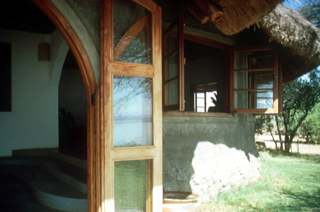View showing the entrance and overhanging thatch roof