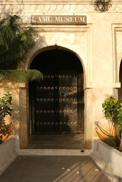 Detail view of museum entrance and nineteenth century brass studded door