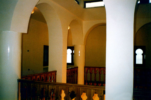 Interior view showing wooden banister and column supports