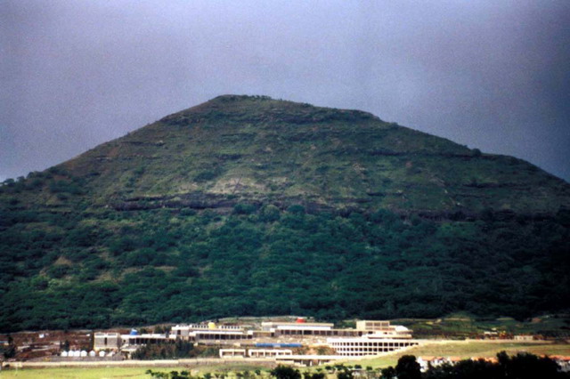 View of complex from highway, with hill in the background
