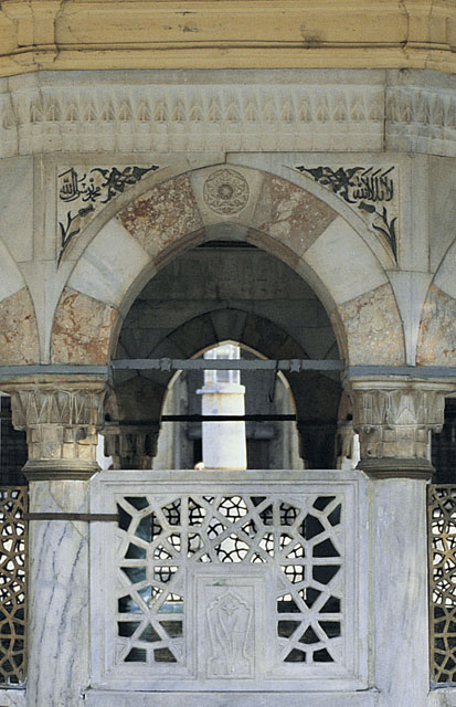 Detail of ablution fountain showing inscriptions in spandrels of polychrome arch