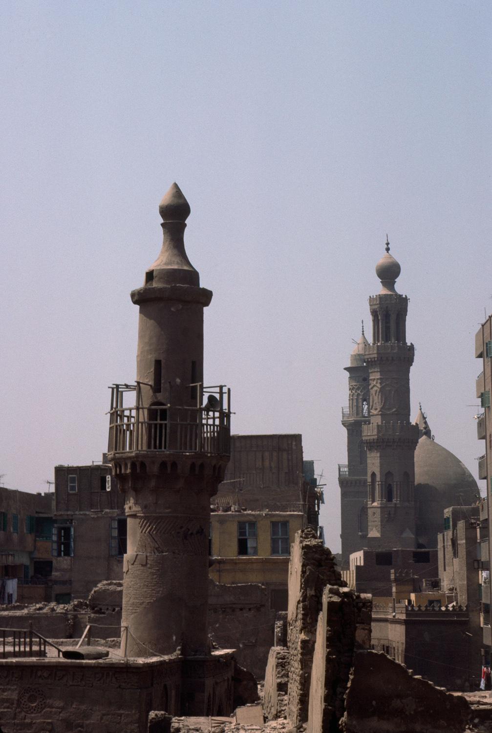Exterior view, fourteenth century minaret. Minarets of Barquq Madrasa and Qalawun Mausoleum are seen in the distance