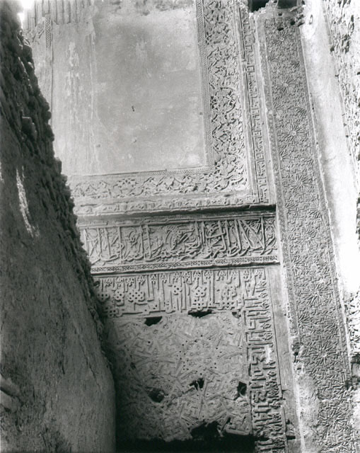 View of Mausoleum of Ghiyath al-Din Sam, prior to reconstruction, showing carved decorations inside entry arch
