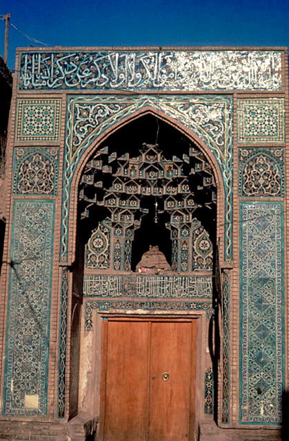 View of tiled pishtaq with muqarnas crown