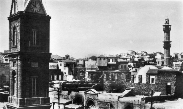 Partial view of the mosque with minaret and eastern gate with Jaffa's clock tower in the foreground