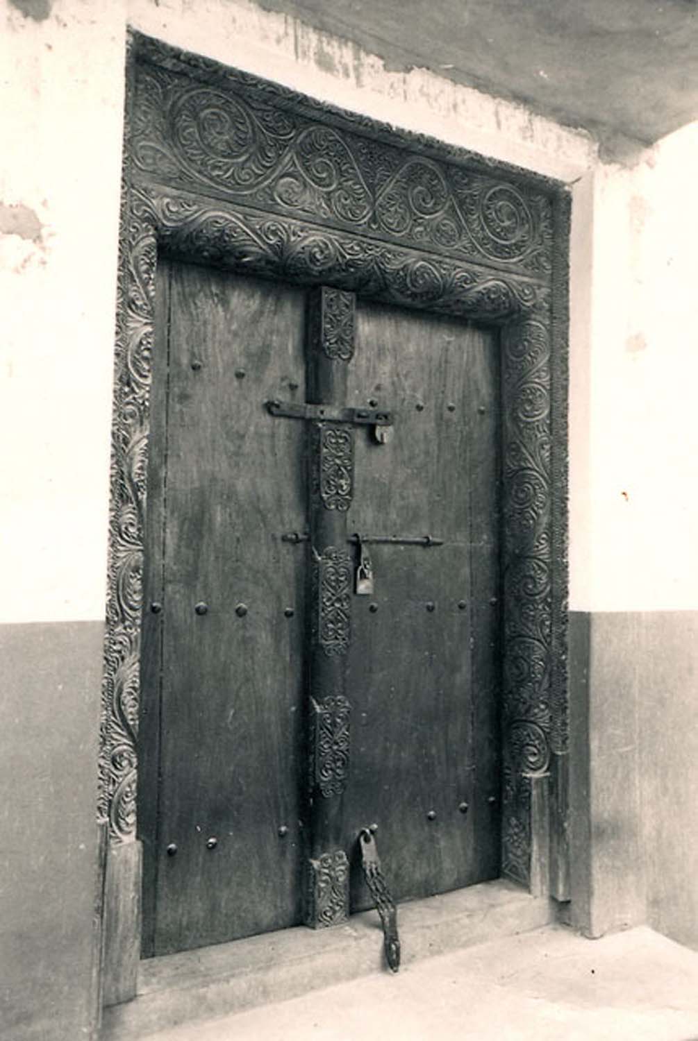 Exterior view of the intricately carved Swahili door in a go-down