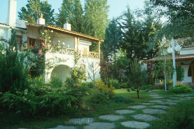 Exterior view along stone path through houses