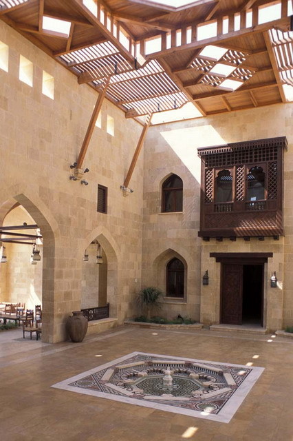 Interior view of marble court with ornamental pool and wooden trellis roof, looking southwest