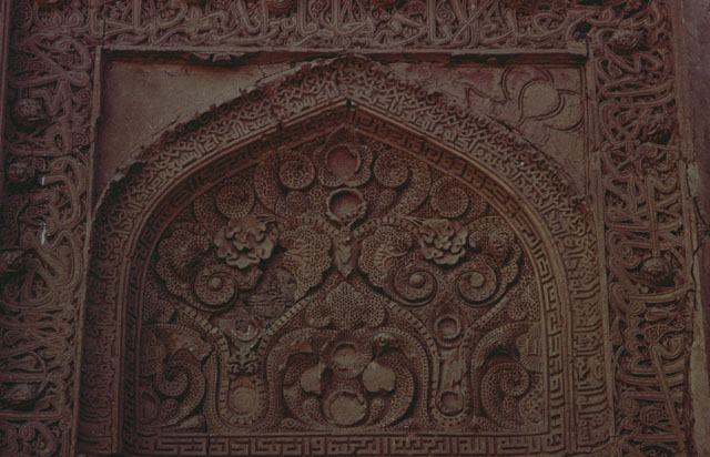 Detail of mihrab, floral arabesques above niche and inscriptive frame