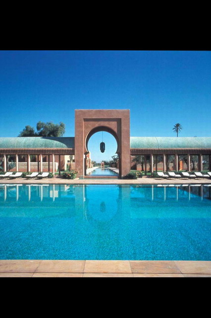 Pool and water canal seen through arch
