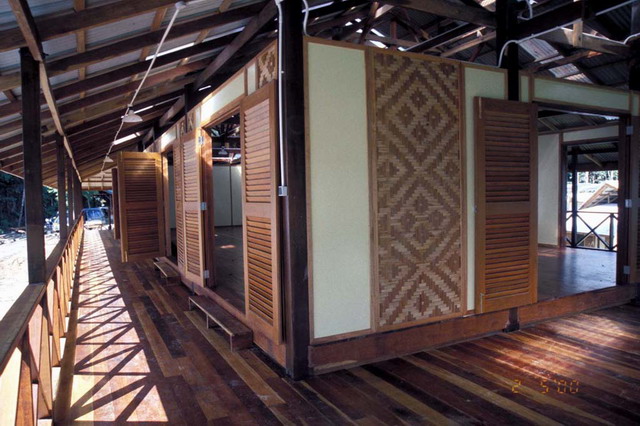 View of corridor, showing louvered doors and reed panel on wall
