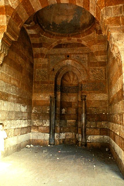Interior view of mihrab, built with alternating bands of white and red stone