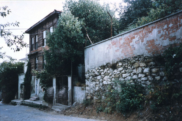 Exterior view of wooden, concrete and stone façade before restoration
