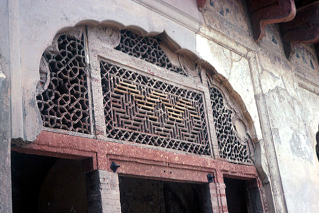 Exterior detail of grillwork on arch of doorway