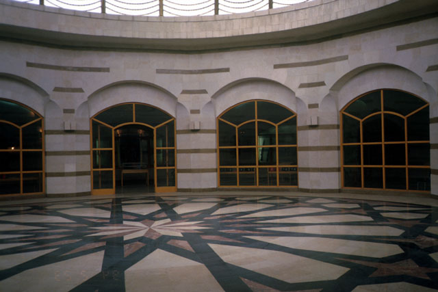 Interior view showing geometric patterned paving under dome