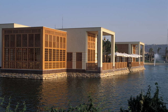 Lakeside Café - Exterior view from west, showing <i>chicha pavilion</i> (left) and terrace along lake