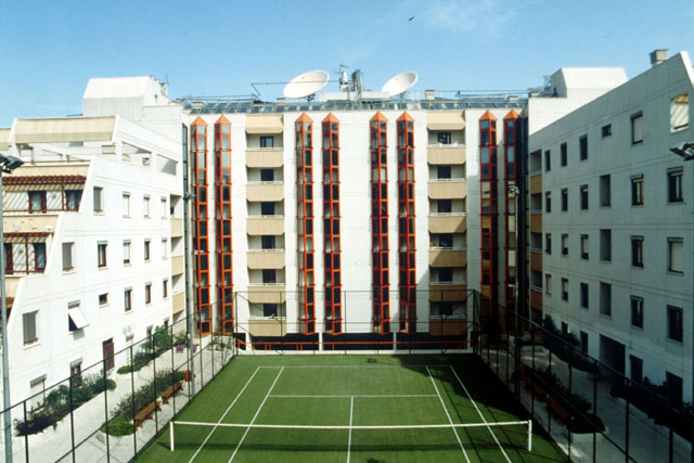 Exterior view showing central courtyard with tennis court