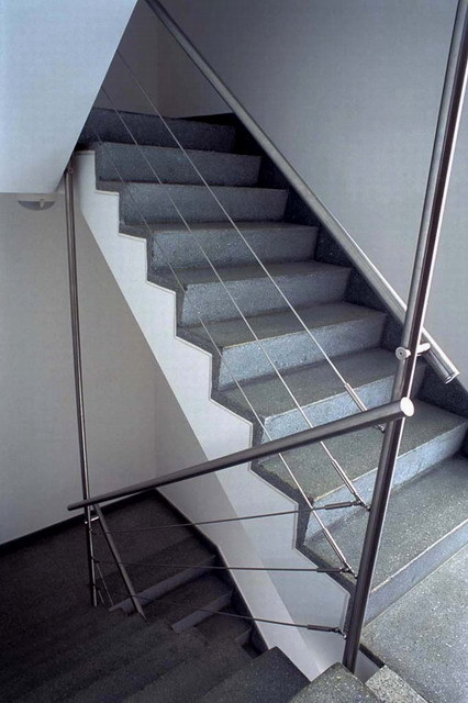 Interior detail of staircase with stainless steel handrail
