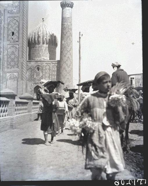 Street scene from the west, on the side of the Registan square, with the southern dome and minaret, and part of the pishtaq