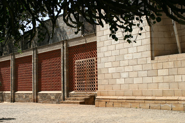 Exterior view, showing lattice fence of museum courtyard