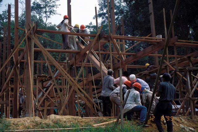 Construction view, with workers on wood structure