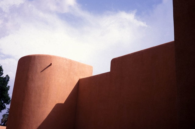 Exterior view; clay-finished wall with round tower