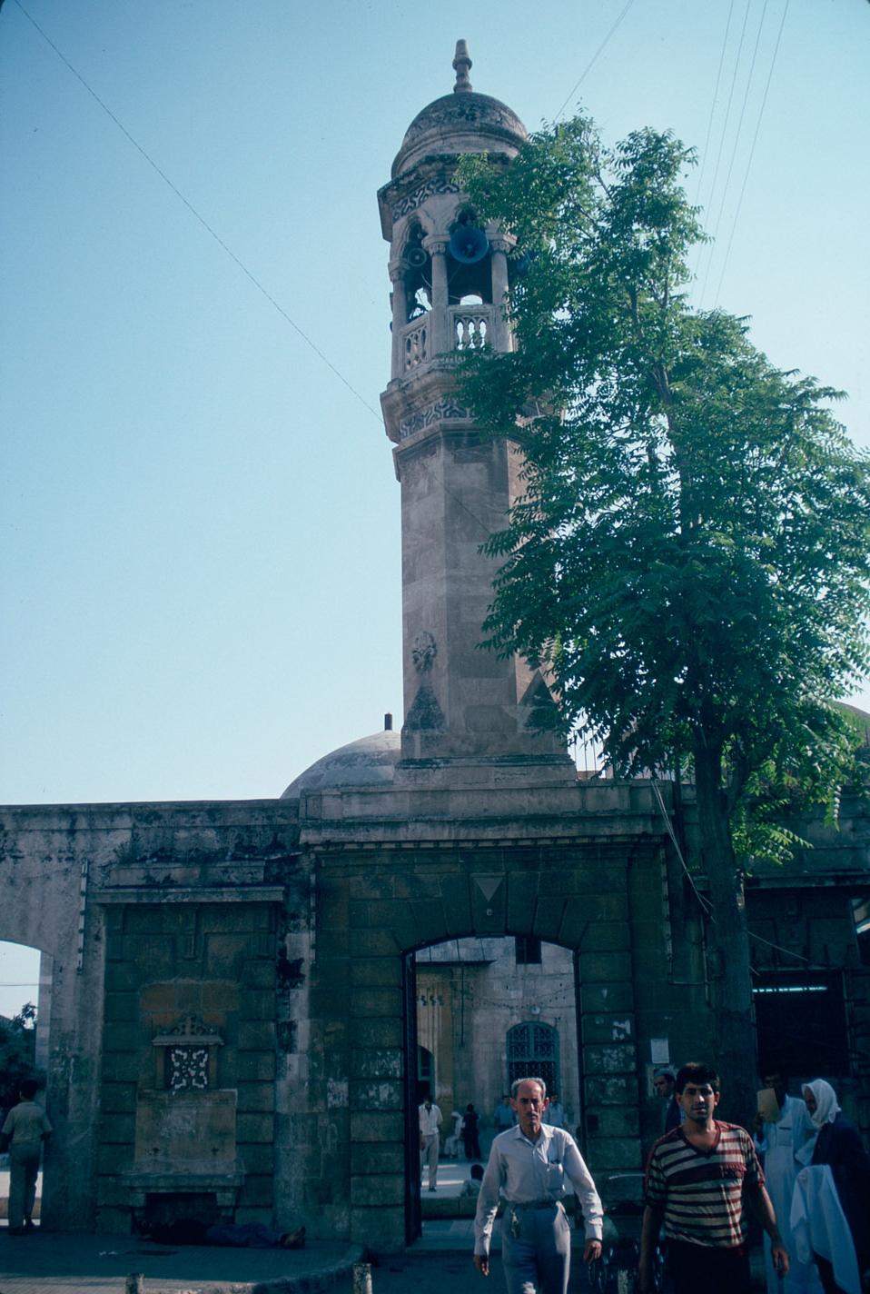 View of minaret above gate, street view